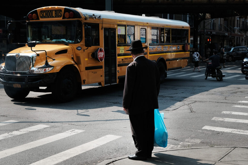 A yeshiva school bus drives through Borough Park on Sept. 12, 2022 in the Brooklyn borough of New York City.