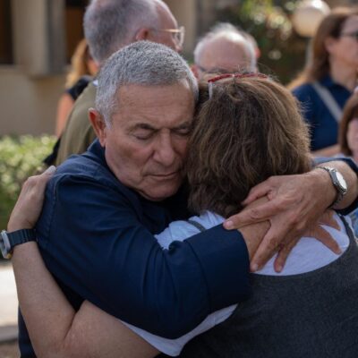 Doron Almog, chairman of the executive of the Jewish Agency for Israel, embraces a JAFI board member at an emergency board meeting at Kibbutz Shfayim where he discussed the importance of the solidarity of the global Jewish community.