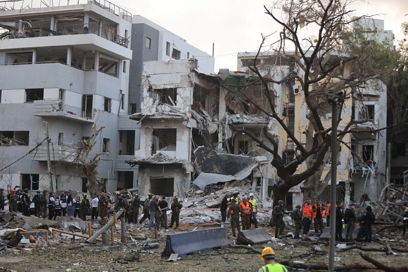 Israeli security and rescue forces work at the scene of an Iranian missile attack in Tel Aviv, central Israel, on June 16, 2025.