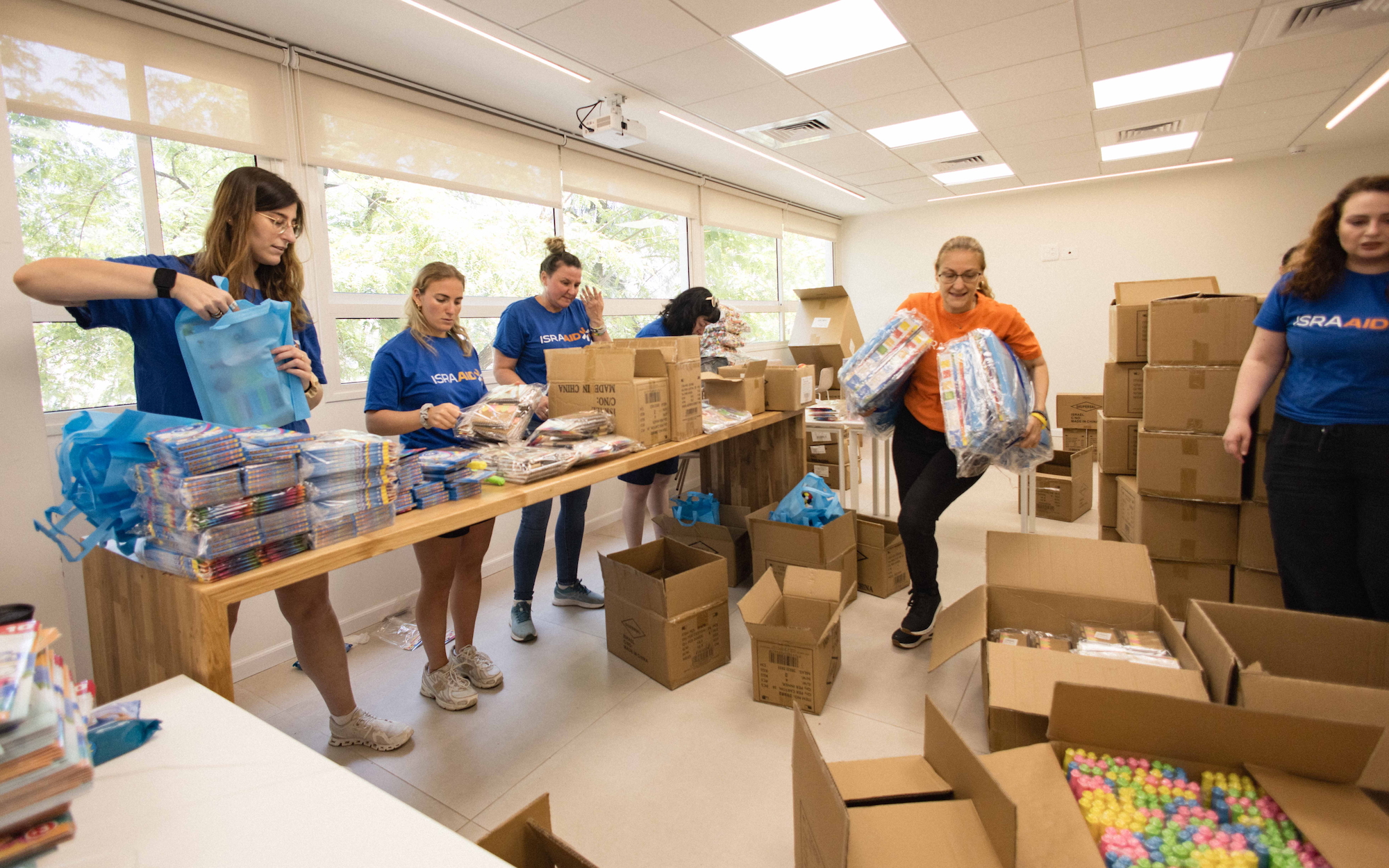 IsraAid workers pack 'resilience' kits for Israeli children affected by Iranian missile attacks, in June 2025.